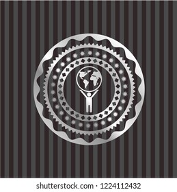man lifting world icon inside silver shiny badge