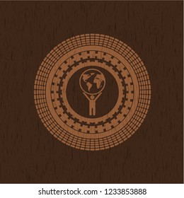 man lifting world icon inside wooden signboards