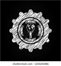 man lifting world icon inside chalk emblem