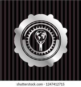 man lifting world icon inside silver badge