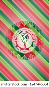 man lifting world icon inside christmas emblem.