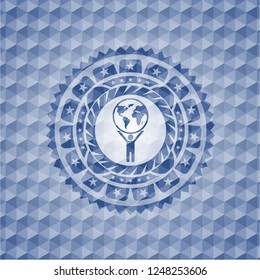man lifting world icon inside blue polygonal badge.