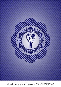 man lifting world icon inside denim background