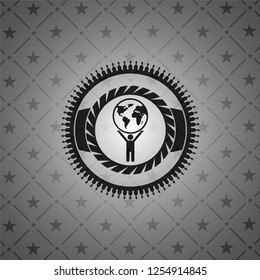 man lifting world icon inside black badge
