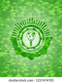 man lifting world icon inside realistic green mosaic emblem