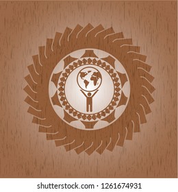 man lifting world icon inside wood emblem