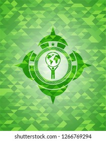 man lifting world icon inside green emblem. Mosaic background
