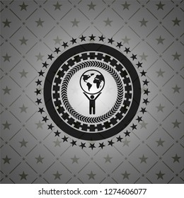 man lifting world icon inside black emblem