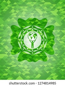 man lifting world icon inside green emblem with mosaic background