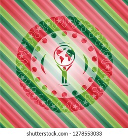 man lifting world icon inside christmas colors style badge.