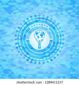 man lifting world icon inside light blue mosaic emblem