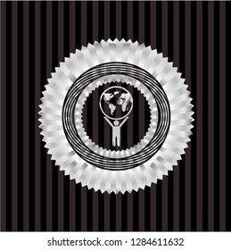 man lifting world icon inside silvery shiny emblem