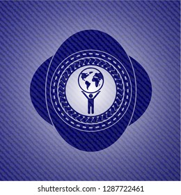 man lifting world icon inside badge with denim texture