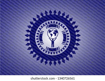 man lifting world icon inside jean or denim emblem or badge background