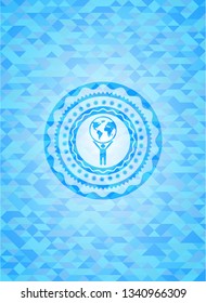 man lifting world icon inside light blue emblem with triangle mosaic background