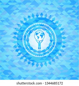 man lifting world icon inside realistic light blue mosaic emblem