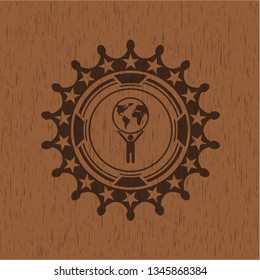 man lifting world icon inside wooden emblem. Vintage.