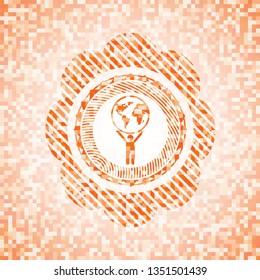 man lifting world icon inside orange mosaic emblem with background