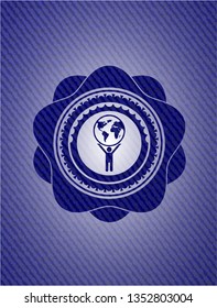 man lifting world icon inside emblem with jean texture