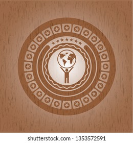 man lifting world icon inside wooden emblem. Vintage.