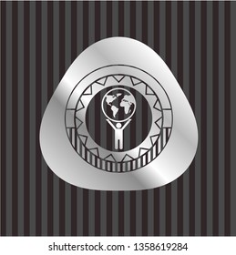 man lifting world icon inside silvery emblem