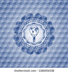 man lifting world icon inside blue polygonal badge.