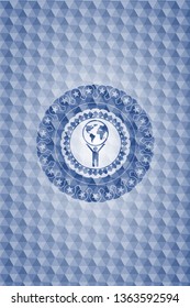 man lifting world icon inside blue emblem with geometric pattern background.