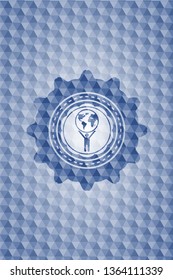man lifting world icon inside blue badge with geometric pattern background.