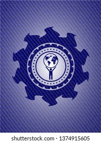 man lifting world icon inside badge with denim texture
