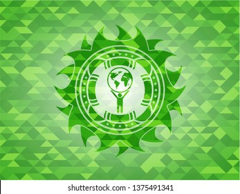 man lifting world icon inside green emblem with mosaic background