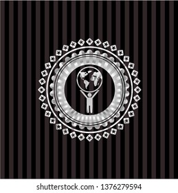 man lifting world icon inside silvery shiny emblem