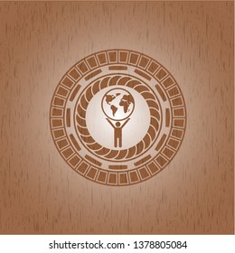 man lifting world icon inside vintage wooden emblem