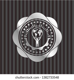 man lifting world icon inside silvery shiny emblem
