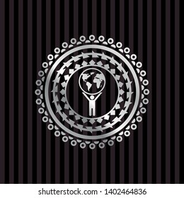 man lifting world icon inside silver shiny badge