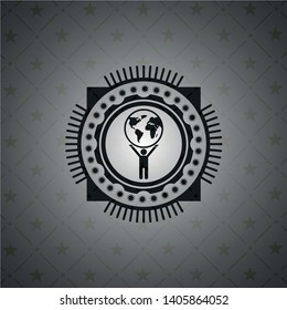 man lifting world icon inside black badge