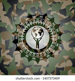 man lifting world icon inside camouflaged emblem