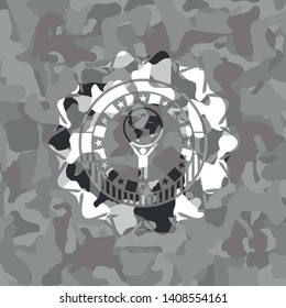 man lifting world icon inside grey camouflage emblem