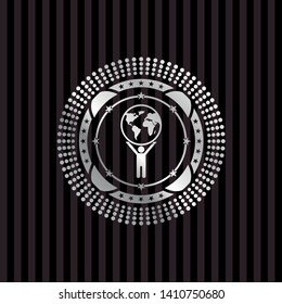 man lifting world icon inside silver shiny emblem