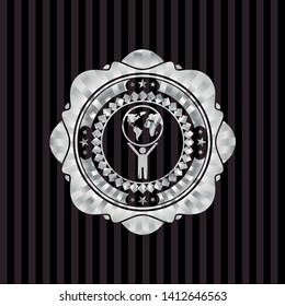 man lifting world icon inside silver shiny badge