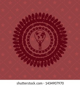 man lifting world icon inside badge with red background