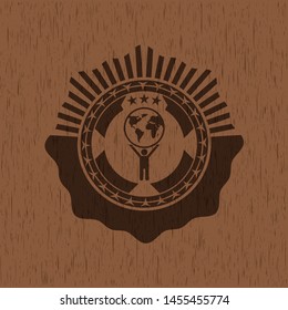 man lifting world icon inside vintage wooden emblem