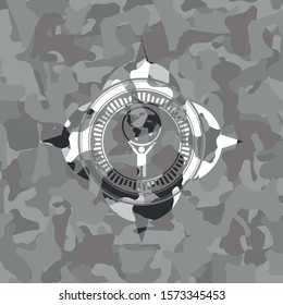 man lifting world icon inside grey camouflage emblem