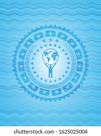 man lifting world icon inside light blue water emblem background.