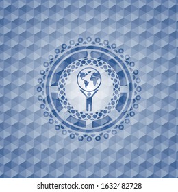 man lifting world icon inside blue emblem with geometric background.
