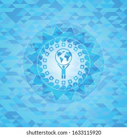 man lifting world icon inside sky blue emblem with triangle mosaic background