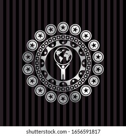 man lifting world icon inside silvery shiny emblem
