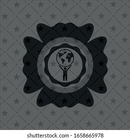 man lifting world icon inside dark badge or emblem
