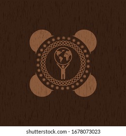 man lifting world icon inside wood emblem. Vintage.