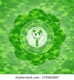 man lifting world icon inside green mosaic emblem. 