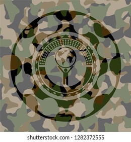 man lifting world icon on camo texture